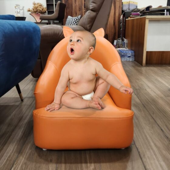 Baby on sofa orange