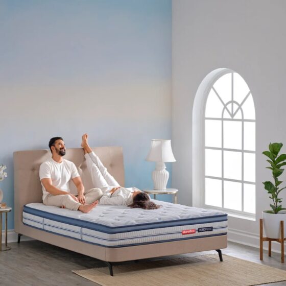 Duroflex_Strength_Plus_Memory_Foam_Coir_Orthopedic-Mattress_With_Euro_Top_couples_sitting_on_it